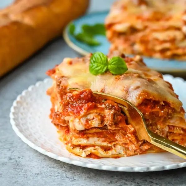 Classic Lasagna Recipe. The perfect lasagna recipe made with parmesan ricotta cheese filling, melted mozzarella cheese, lasagna noodles, and a robust tomato meat sauce. It is the best lasagna recipe!