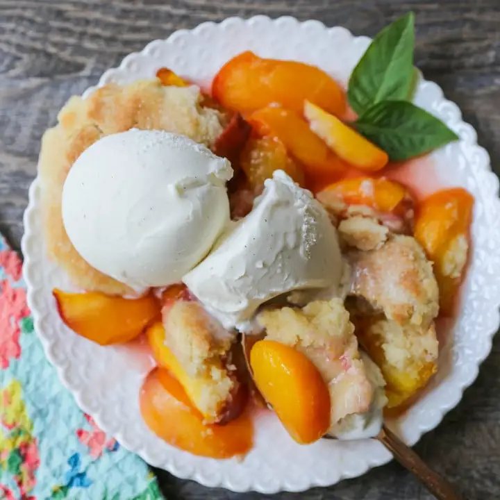 Peach Cobbler. The Best Peach Cobbler Recipe! Fresh peaches tossed with a touch of sugar and topped with a homemade sweet and buttery topping that resembles a mix of a sugar cookie and a sweet biscuit.