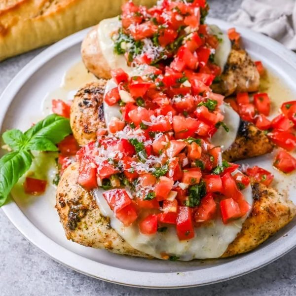Bruschetta Grilled Chicken combines tender Italian grilled chicken breasts with juicy, garlicky tomato bruschetta, creamy melted mozzarella cheese, and a drizzle of balsamic glaze.
