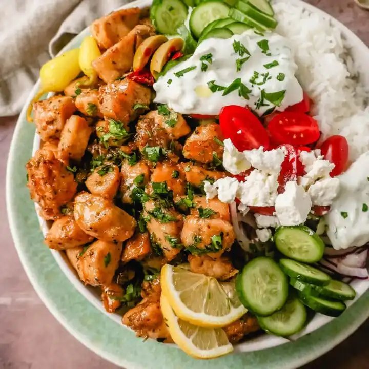 How to make the Best Greek Chicken Bowls. Grilled Greek Lemon Chicken, cucumber, tomatoes, red onion, kalamata olives, feta cheese, and homemade tzatziki sauce all in one bowl. A high-protein and low-carb meal!
