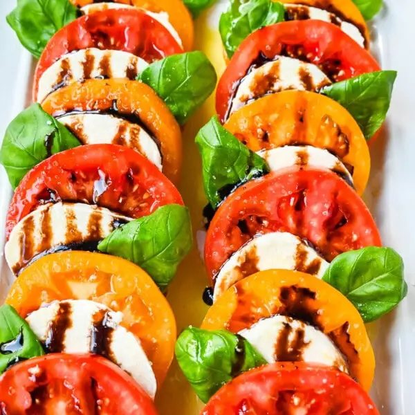 This caprese salad is the ultimate fresh summer dish, made with juicy, colorful heirloom tomatoes, creamy mozzarella, balsamic glaze and fragrant basil. If you’re looking for a fresh tomato salad recipe that’s both beautiful and delicious, this is it.