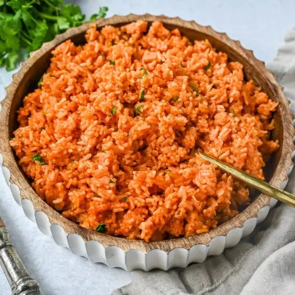This easy Spanish Rice Recipe — also known as Mexican rice — is a flavorful, vibrant side dish made with sautéed onions, long-grain rice, Mexican spices, and fresh tomato sauce. This is the best Spanish rice recipe and is so easy to make!