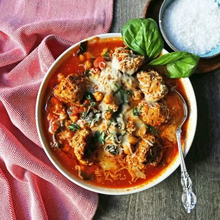 Healthy Spicy Turkey Meatball Soup A healthy soup made with lean turkey meatballs, spinach, chickpeas, marinara sauce, and parmesan cheese. Gluten-Free Turkey Meatball Soup. Low-carb soup recipe. www.modernhoney.com #turkeymeatballsoup #lowcarb #glutenfree #turkeymeatball