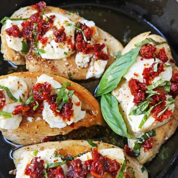 Chicken Bryan. Grilled chicken with a basil lemon butter sauce topped with sundried tomatoes and creamy goat cheese. A Carrabba's favorite! www.modernhoney.com #chickenbryan #carrabbas #chicken
