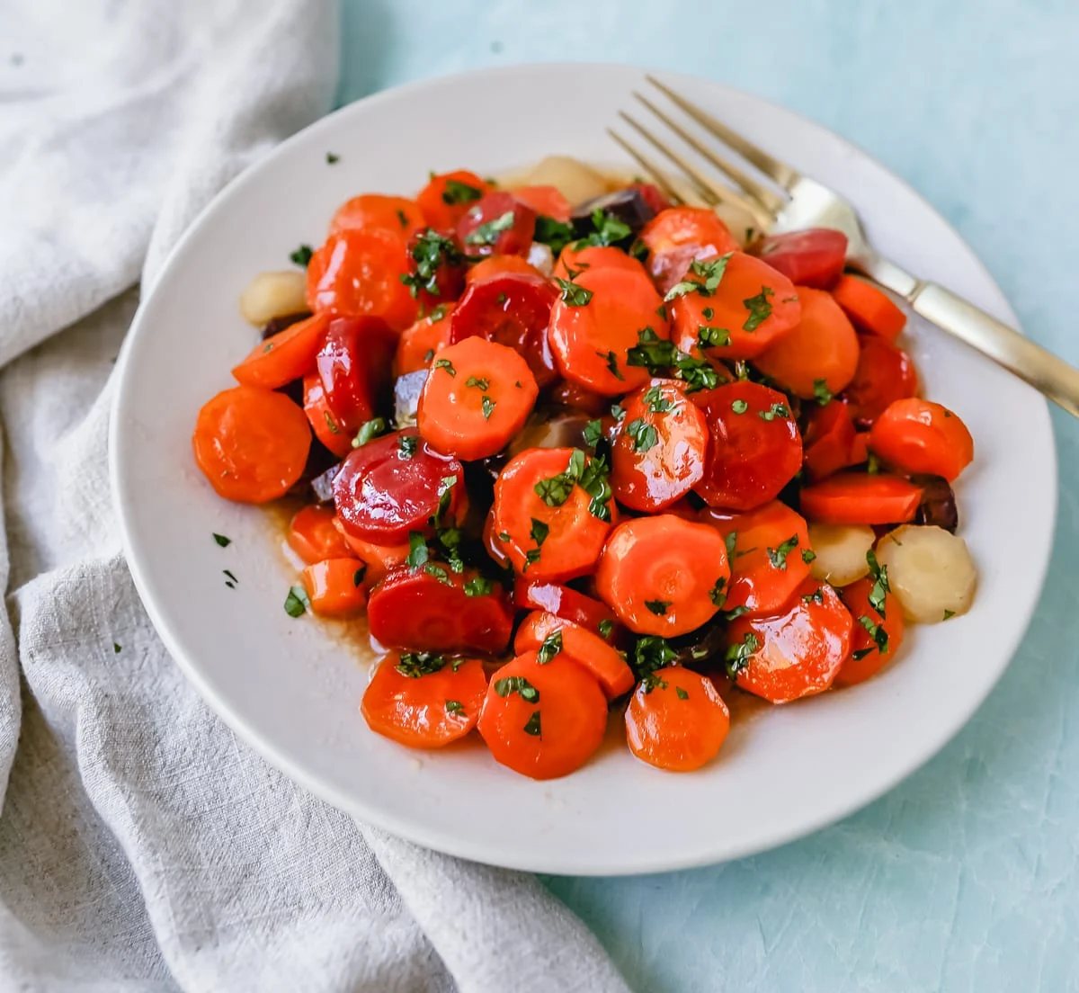These roasted carrots are made with butter, honey, salt, and a touch of fresh lemon zest. These are the best honey glazed carrots and a perfect classic side dish.