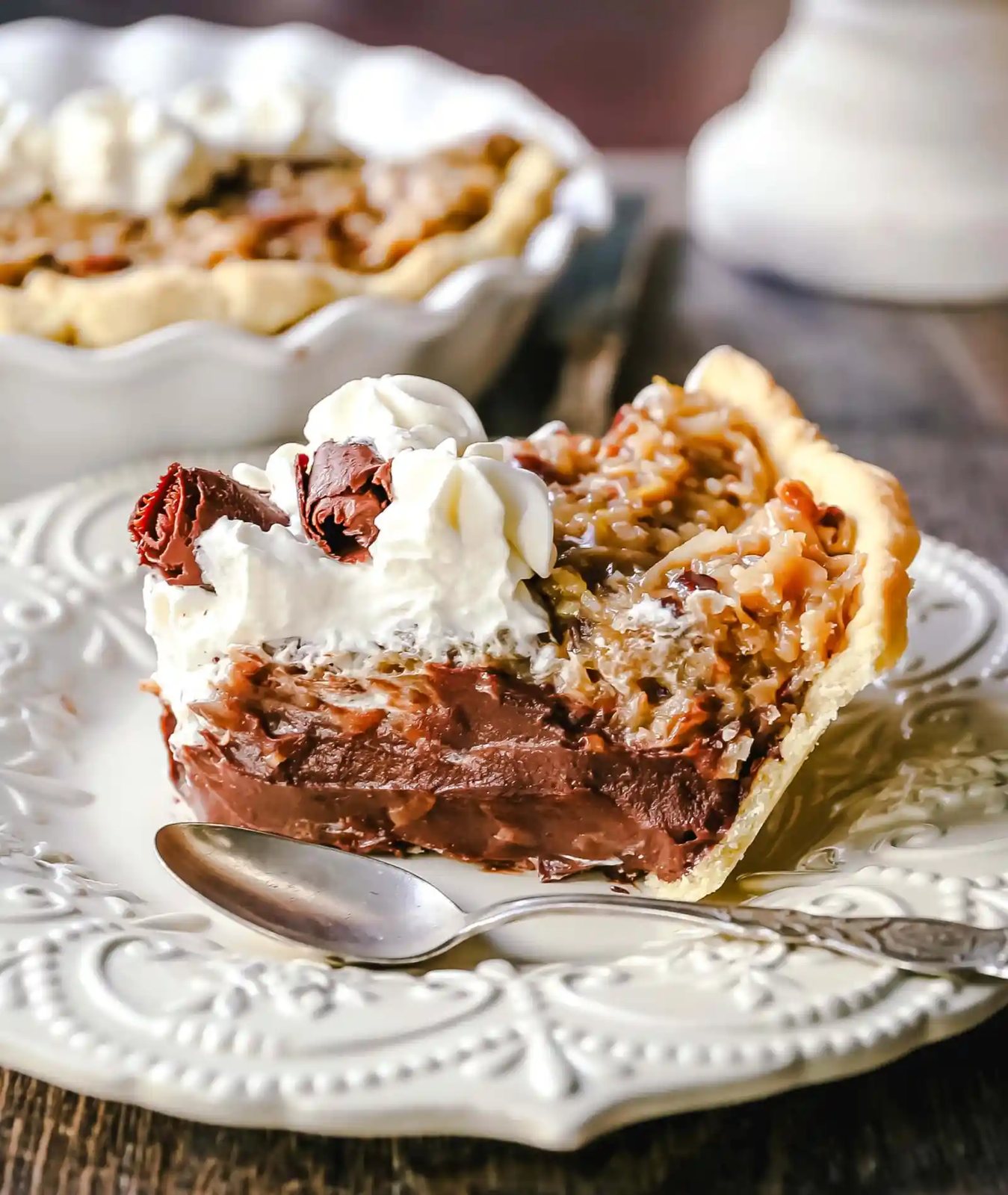 German Chocolate Pie. Creamy rich chocolate pie with a sticky German chocolate coconut-pecan topping and fresh whipped cream and chocolate shavings. www.modernhoney.com #pie #chocolatepie #germanchocolate