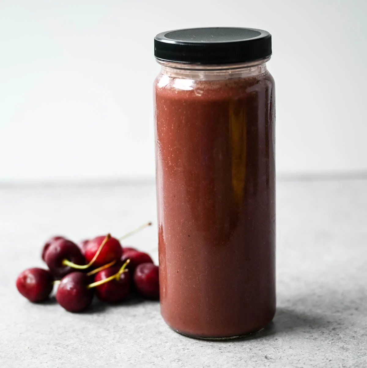 Rich, slightly nutty, and dessert-like, this cherry almond smoothie is packed with protein — a great post-workout recovery drink or afternoon pick-me-up. Cherry almond protein smoothie topped with coconut flakes and almond butter