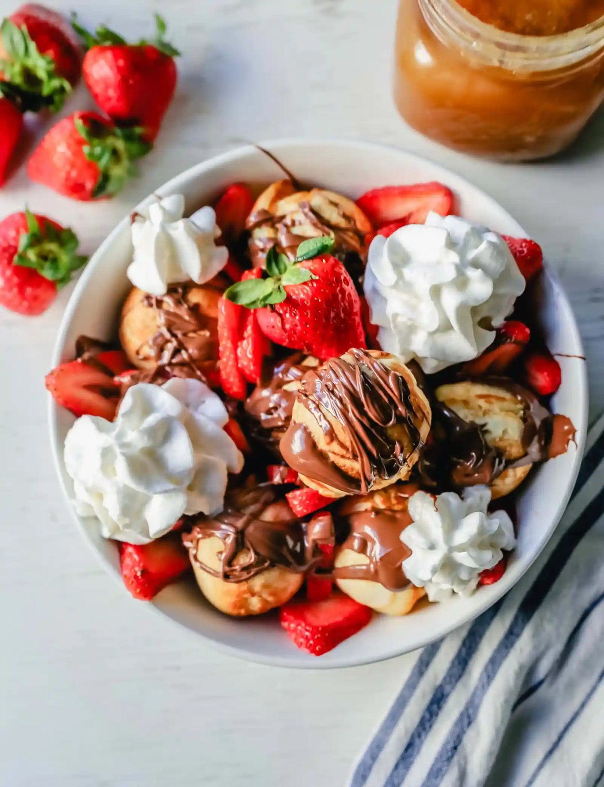 Aebleskiver Danish Pancakes a traditional Danish breakfast or dessert popular in Denmark is a circle pancake cooked in an aebleskiver pan and served with jam, powdered sugar, syrup, and fruit. www.modernhoney.com #aebleskivers #danishpancakes #pancakes