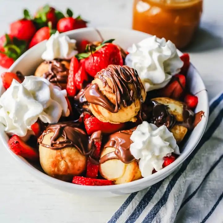Aebleskiver Danish Pancakes a traditional Danish breakfast or dessert popular in Denmark is a circle pancake cooked in an aebleskiver pan and served with jam, powdered sugar, syrup, and fruit. www.modernhoney.com #aebleskivers #danishpancakes #pancakes