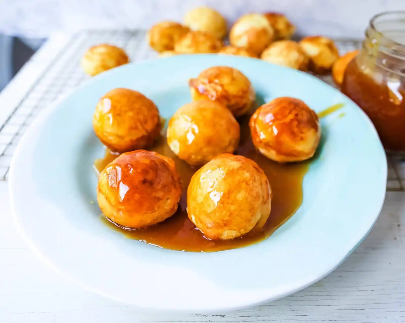 Aebleskiver Danish Pancakes a traditional Danish breakfast or dessert popular in Denmark is a circle pancake cooked in an aebleskiver pan and served with jam, powdered sugar, syrup, and fruit. www.modernhoney.com #aebleskivers #danishpancakes #pancakes