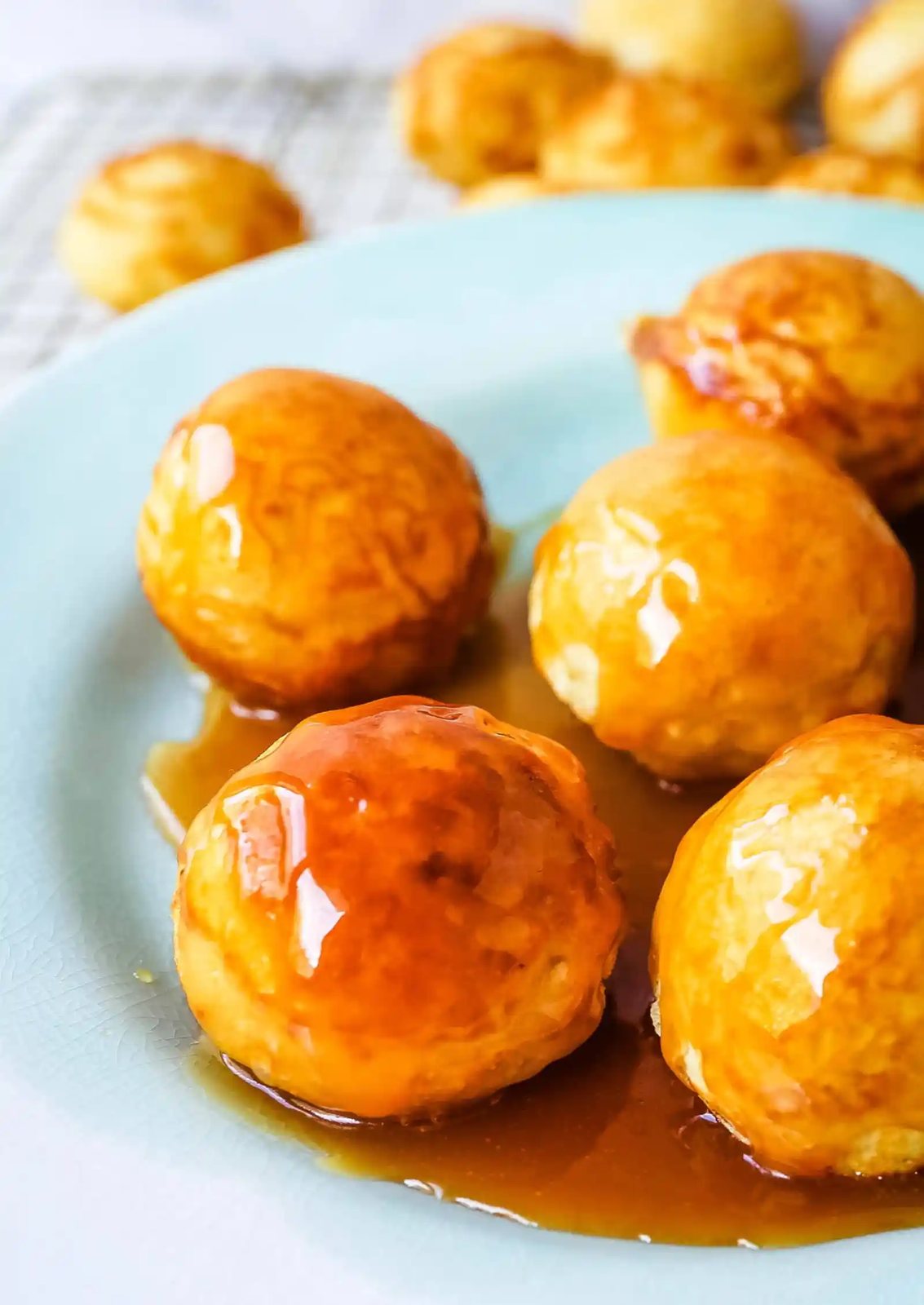 Aebleskiver Danish Pancakes a traditional Danish breakfast or dessert popular in Denmark is a circle pancake cooked in an aebleskiver pan and served with jam, powdered sugar, syrup, and fruit. www.modernhoney.com #aebleskivers #danishpancakes #pancakes