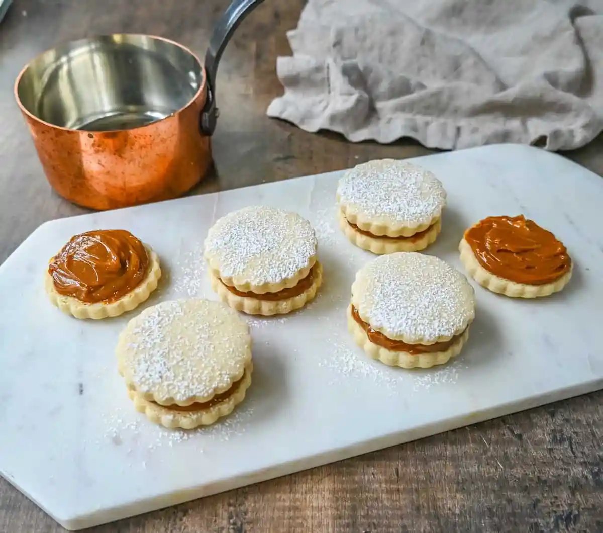 Alfajores Dulce de Leche Sandwich Cookies. These alfajores are a popular sandwich cookie around the world are made with two soft and buttery shortbread cookies filled with rich dulce de leche filling.