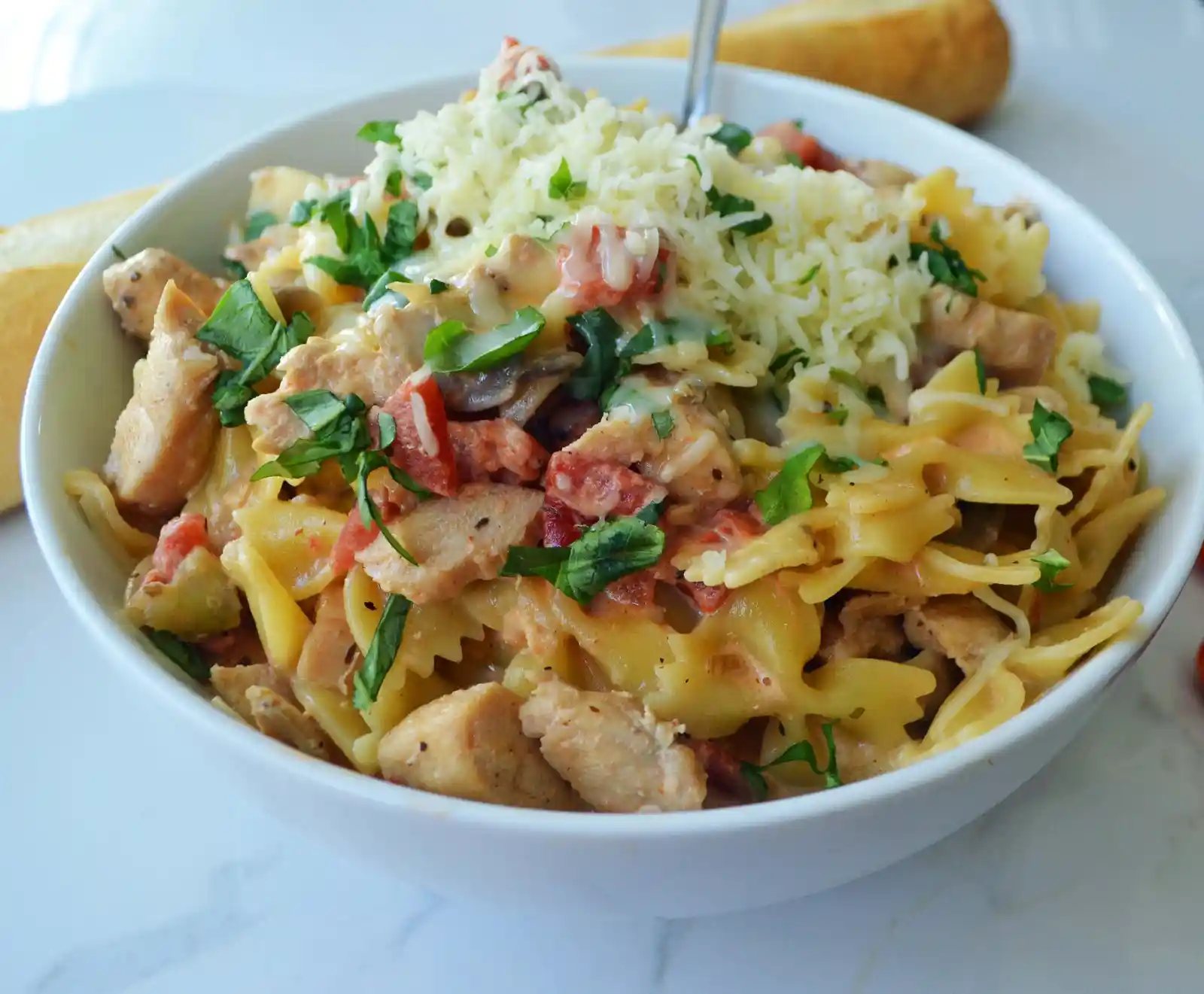 All Dressed Up Bowtie Chicken Pasta. Sauteed Chicken, Artichokes, Roasted Tomatoes, Heavy Cream, Fresh Basil, and Parmesan Cheese all tossed with Bowtie Pasta. Modern Honey - www.modernhoney.com