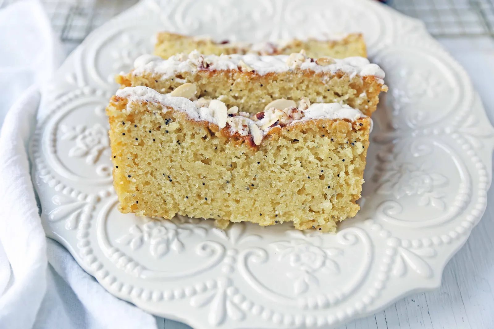 Almond Poppyseed Bread. Soft and moist poppyseed bread with vanilla bean almond glaze and candied almonds. The perfect poppyseed bread recipe. www.modernhoney.com #poppyseedbread #almondbread #quickbread