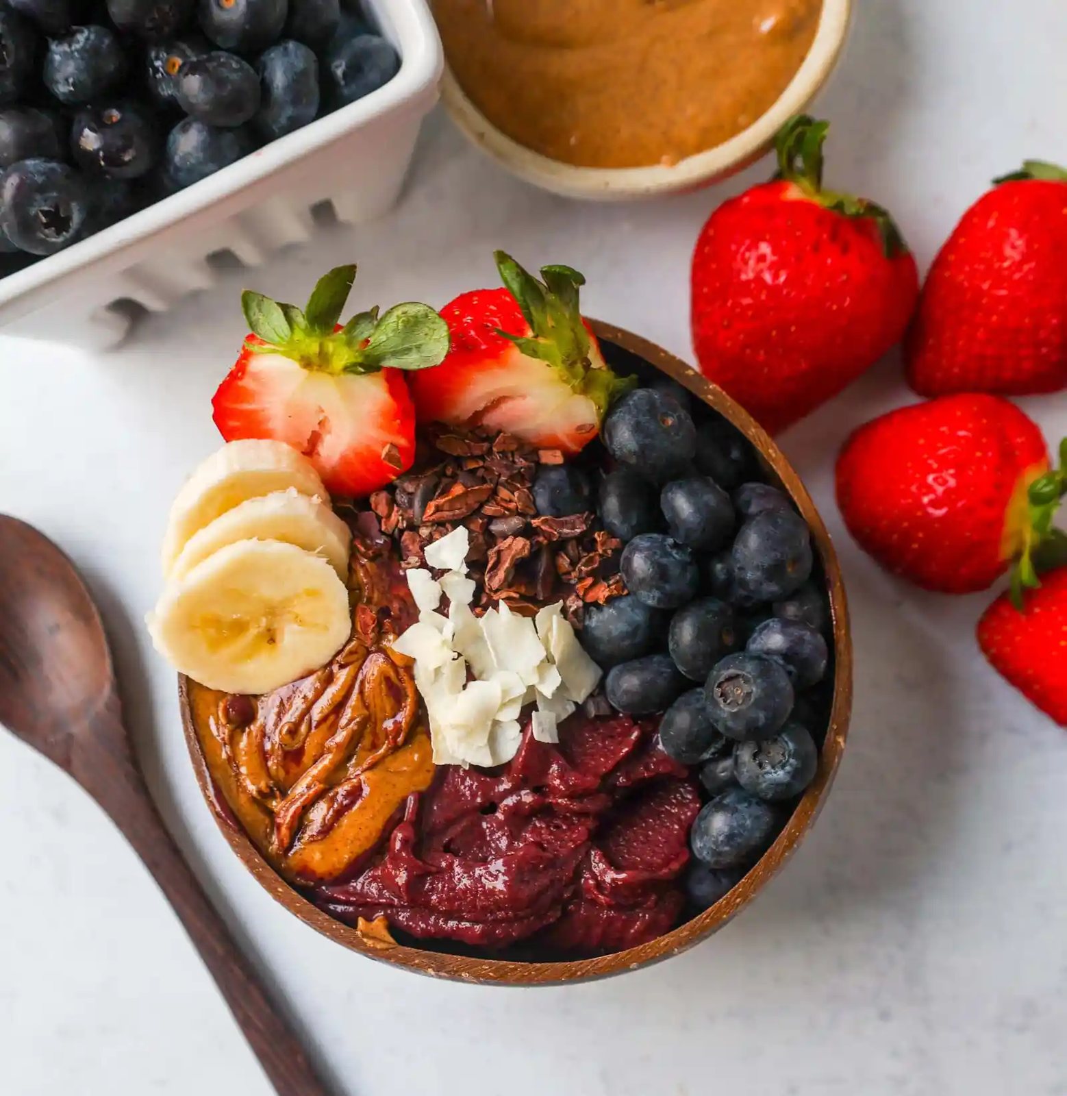 Homemade Acai Bowl Recipe is made with a Brazilian berry mixed with frozen fruits and topped with fresh fruit and granola. I will share tips on how to make the popular acai smoothie bowls at home for a fraction of the price.