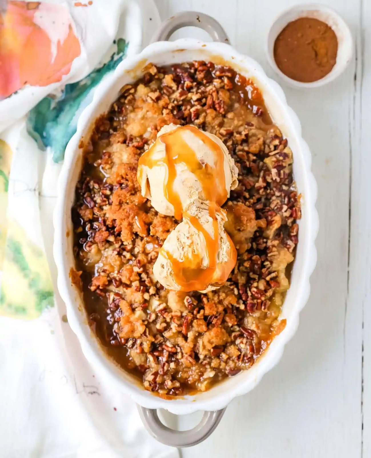 Apple Crisp. A classic Fall dessert made with sweet and tart apples and a homemade buttery brown sugar topping. This Apple Crisp recipe is made with freshly chopped sweetened apples with a handcrafted brown sugar crumble. It is a warm comforting dessert topped with vanilla bean ice cream and salted caramel. www.modernhoney.com #applecrisp #appledesserts #appledessert #dessert