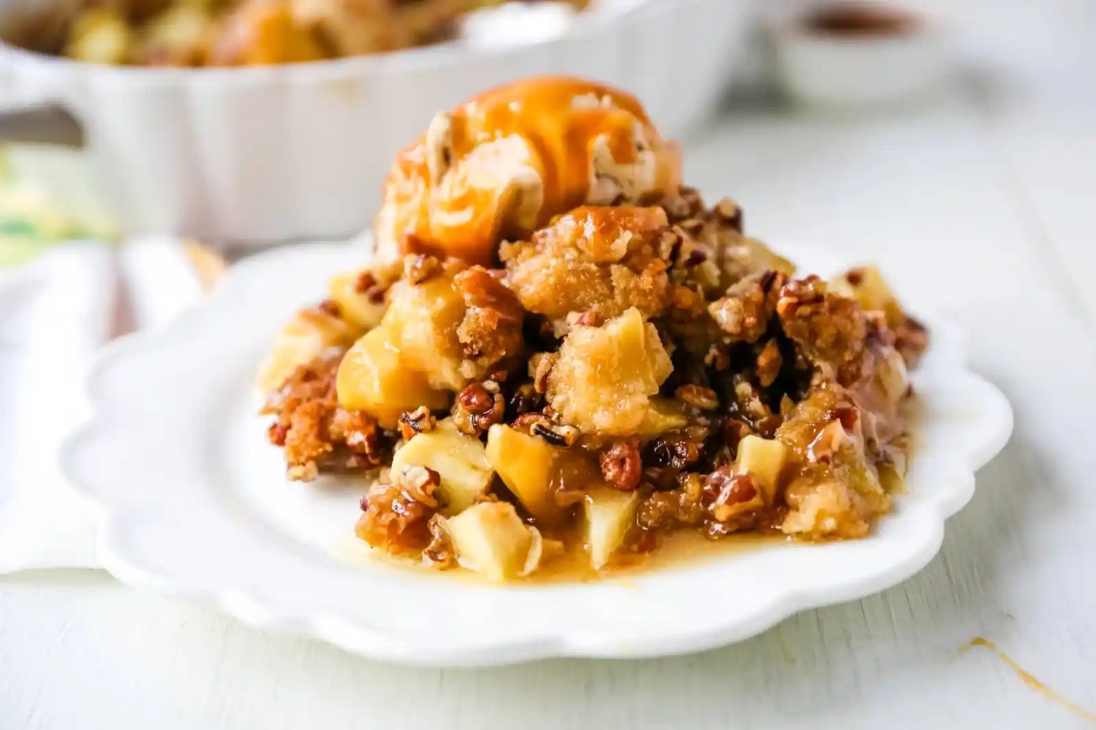 Apple Crisp. A classic Fall dessert made with sweet and tart apples and a homemade buttery brown sugar topping. This Apple Crisp recipe is made with freshly chopped sweetened apples with a handcrafted brown sugar crumble. It is a warm comforting dessert topped with vanilla bean ice cream and salted caramel. www.modernhoney.com #applecrisp #appledesserts #appledessert #dessert
