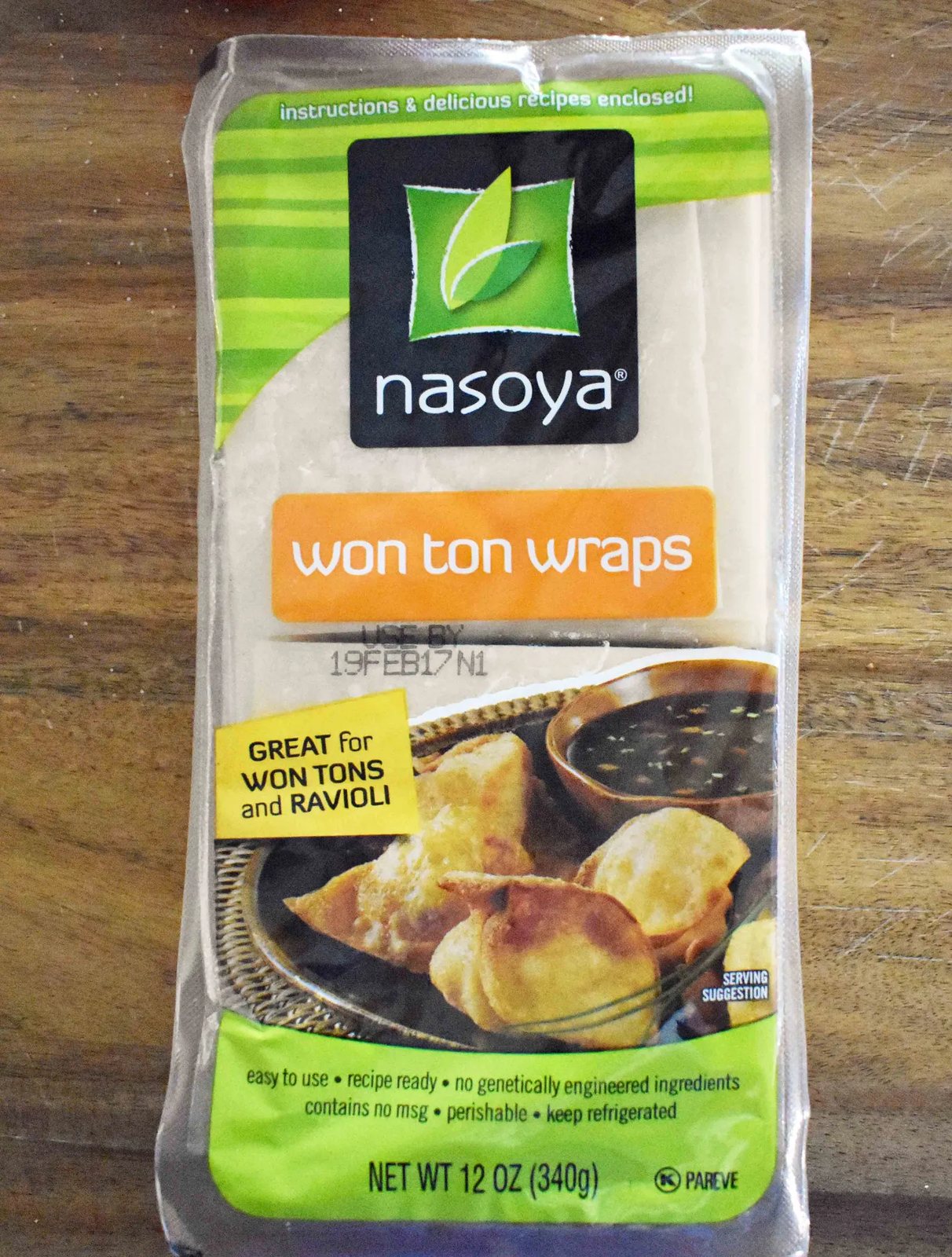 Asian Wonton Chicken Nachos. Fried wontons, pulled chicken, sriracha cream, cabbage mix, and sweet cilantro sauce. An Asian twist on nachos for the perfect party appetizer.
