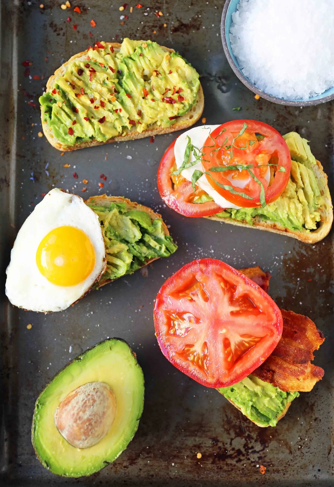Avocado Toast -- 4 Ways. How to make perfect avocado toast. Caprese Avocado Toast, BAT Bacon Avocado Tomato Avocado Toast, Fried Egg Avocado Toast, Avocado Toast with Sea Salt and Chili Flakes. Tips and tricks for making the best avocado toast. www.modernhoney.com #avocadotoast #avocados #avocado