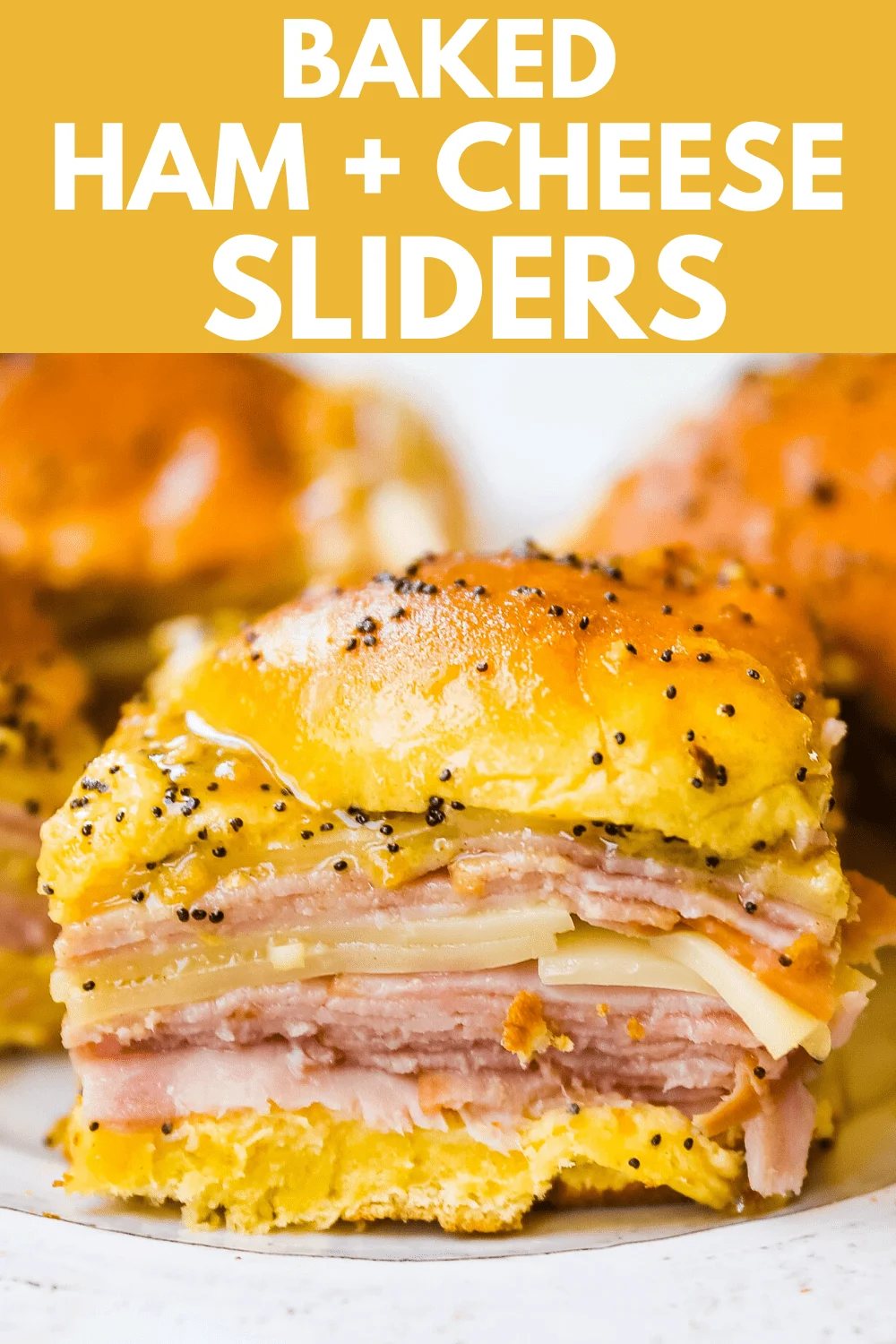 Ham and Cheese Sliders These baked ham and cheese sliders and layered with ham, melted cheese, on a Hawaiian sweet roll, and basted with a flavorful, buttery sauce. www.modernhoney.com #sandwiches #sliders #hamandcheesesliders