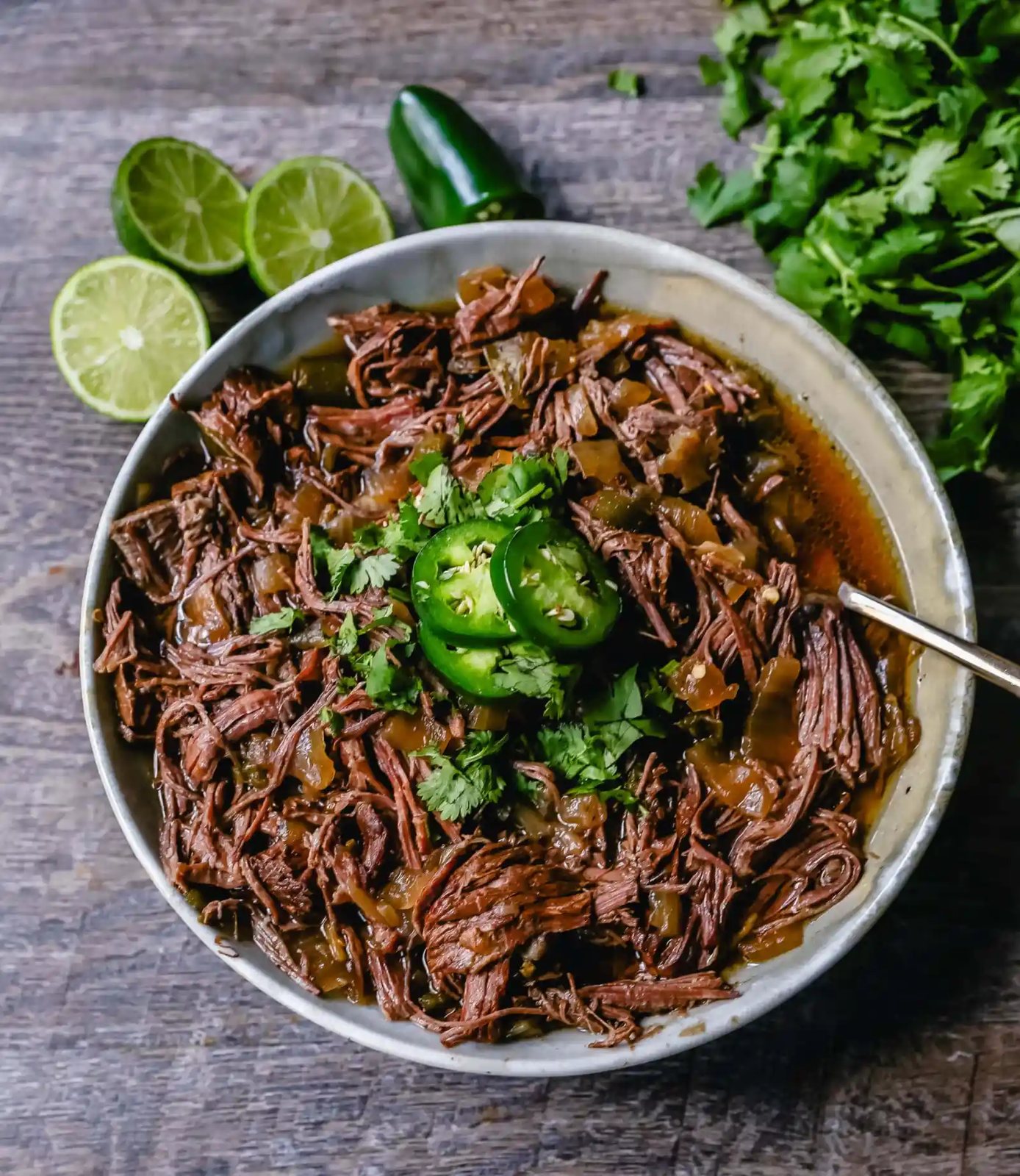 Slow Cooker Barbacoa Beef Tender, flavorful, slow-cooked beef with onions, jalapenos, and spices make this the perfect barbacoa beef for burritos, tacos, enchiladas, quesadillas, on a salad, or just on its own with a few side dishes.