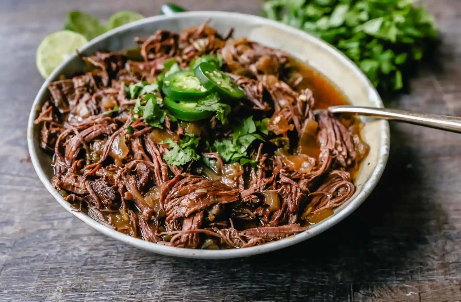 Slow Cooker Barbacoa Beef Tender, flavorful, slow-cooked beef with onions, jalapenos, and spices make this the perfect barbacoa beef for burritos, tacos, enchiladas, quesadillas, on a salad, or just on its own with a few side dishes.