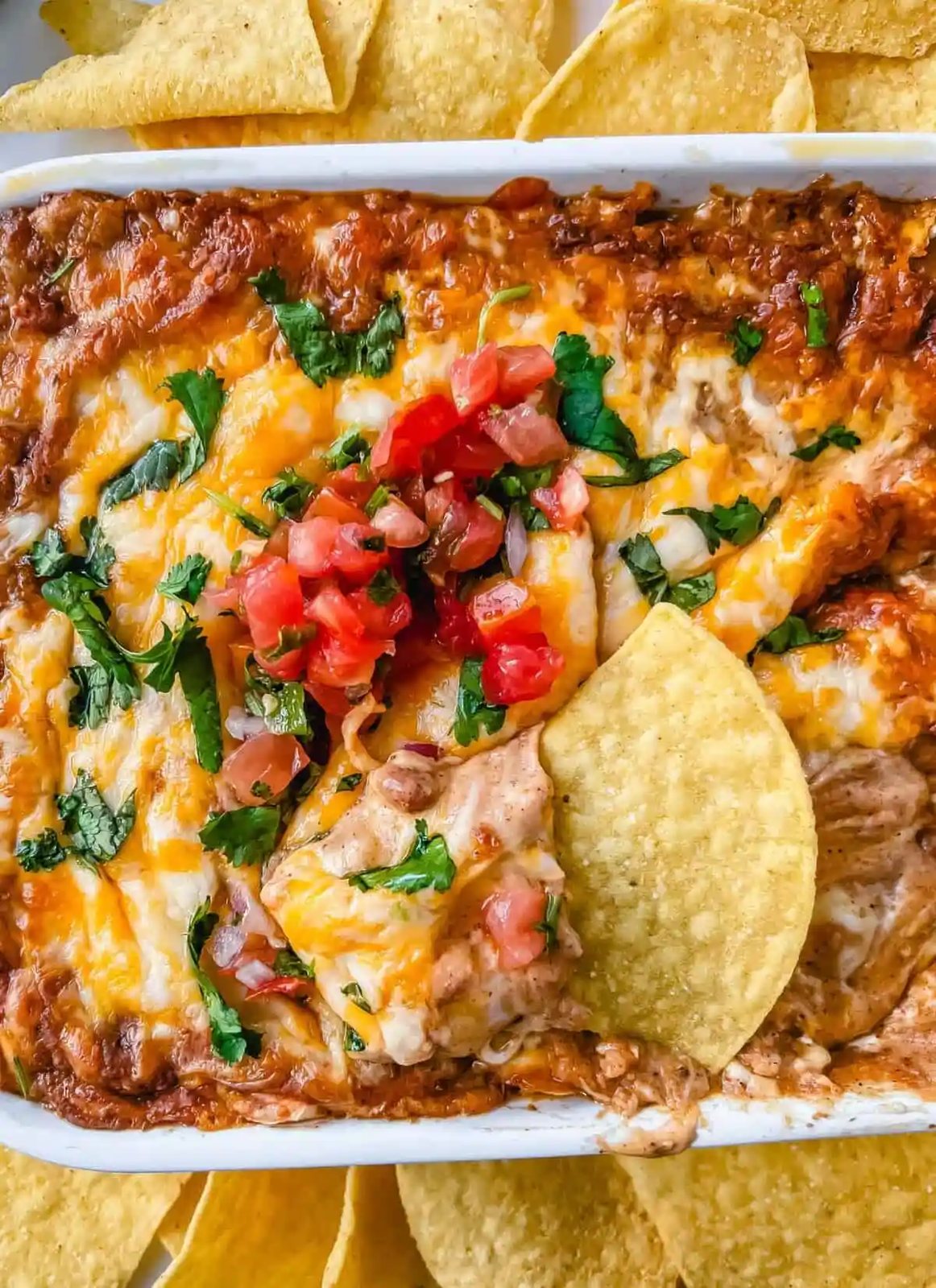 This is the best bean dip recipe ever! This is such an easy bean and cheese dip made with creamy beans, sour cream, cream cheese, taco seasoning, hot sauce, and lots of Mexican cheese! This easy bean dip is the best appetizer recipe.