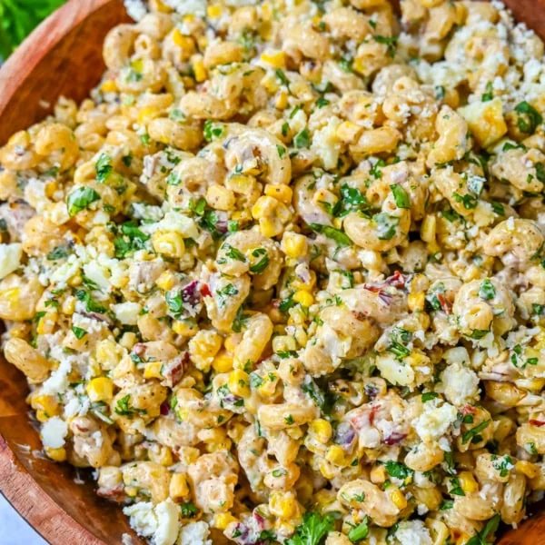 This Mexican Street Corn Pasta Salad is made with fresh corn, pasta, red onion, jalapeno, fresh cilantro, all tossed in a perfectly spiced dressing and topped with cotija cheese, Mexican spices, and fresh lime. It’s street food meets comfort food and it is so addictive. Perfect for a summer BBQ, potluck dish, or the perfect side dish, this Mexican Street Corn Pasta Salad delivers every time.