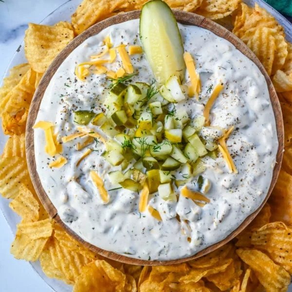 This Dill Pickle Dip is creamy, tangy, and the ultimate party dip for pickle lovers! Made with Greek yogurt, cream cheese, and sour cream for the perfect balance of creamy and zesty, it’s loaded with chopped dill pickles, fresh dill, sharp cheddar, and a touch of spice!