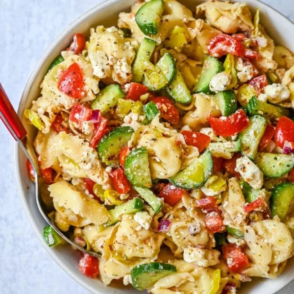 Greek Cheese Tortellini Pasta Salad with fresh tomatoes, cucumbers, red onion, feta cheese, tossed in a tangy homemade Greek dressing. This is such an easy tortellini pasta salad recipe and everyone loves it!