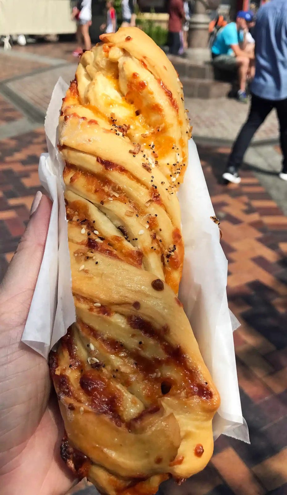 Cheddar Garlic Bagel Twist at Disneyland. The Best Eats and Treats at Disneyland. The best food to eat at Disneyland. A list of the most popular and favorite food at Disneyland parks. A list of what to eat at Disneyland. www.modernhoney.com