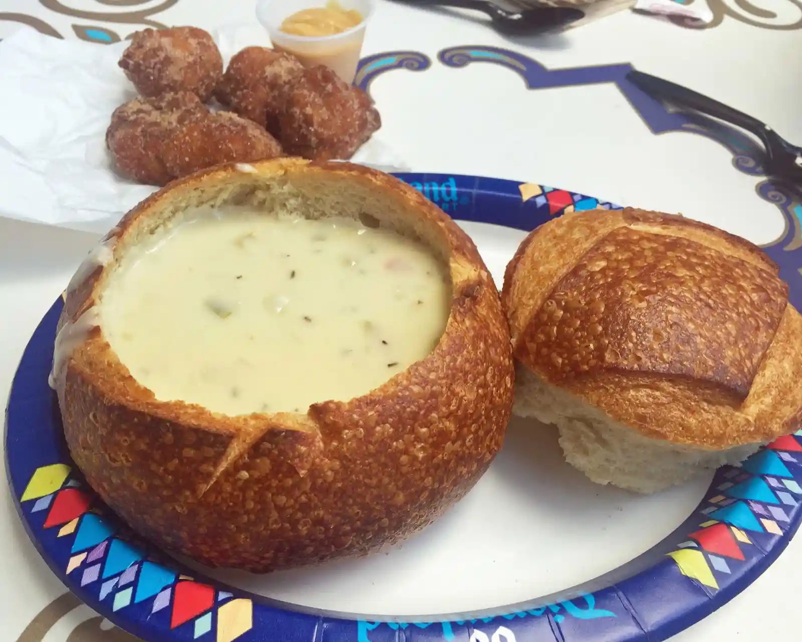 Fritters and Clam Chowder in Sourdough Bread Bowl. The Best Eats and Treats at Disneyland. The best food to eat at Disneyland. A list of the most popular and favorite food at Disneyland parks. A list of what to eat at Disneyland. www.modernhoney.com