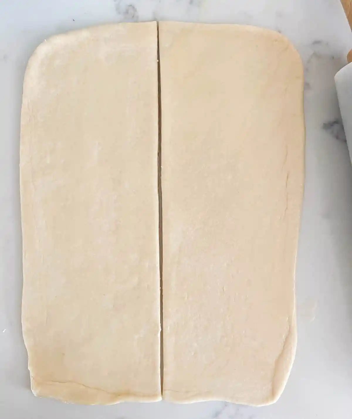 Parker House Dough Ball into rectangle and cutting in half. How to make homemade Parker House Rolls from scratch.