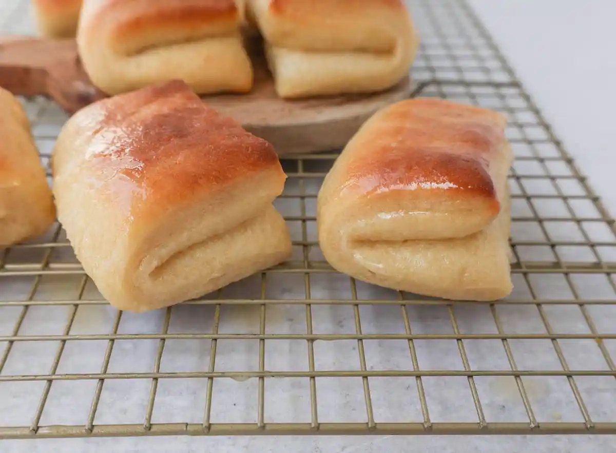 The Famous Parker House Rolls are light, fluffy, and buttery with a secret ingredient that make them tender and melt in your mouth. This the best parker house roll recipe!