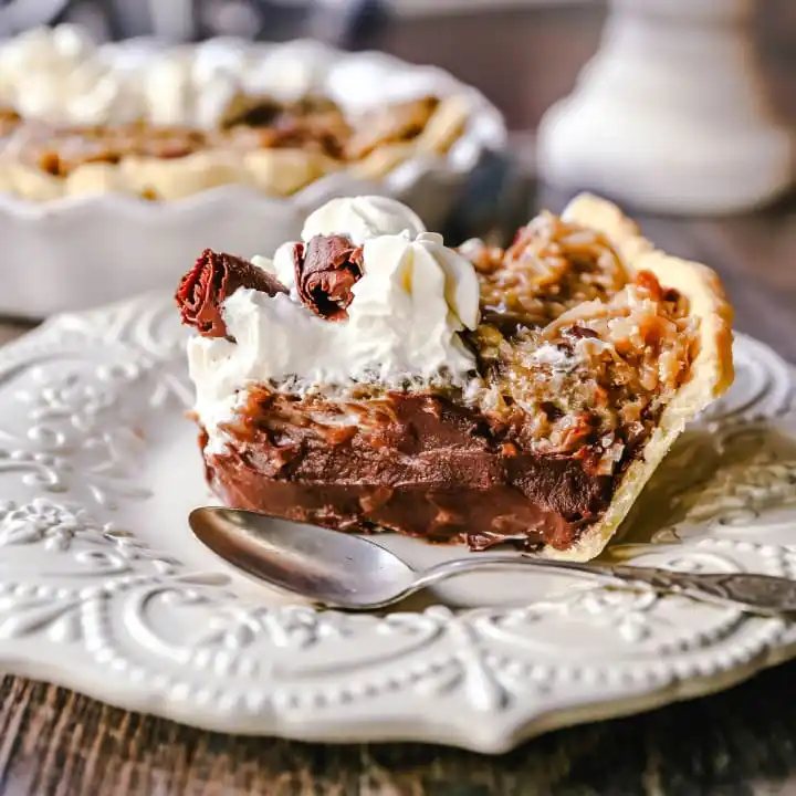 German Chocolate Pie. Creamy rich chocolate pie with a sticky German chocolate coconut-pecan topping and fresh whipped cream and chocolate shavings. www.modernhoney.com #pie #chocolatepie #germanchocolate