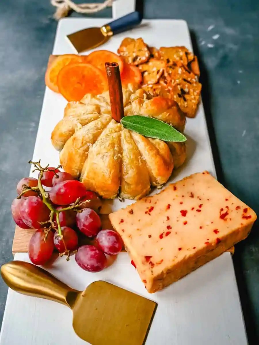 Pumpkin Shaped Baked Brie Puff Pastry. This festive Fall Pumpkin Baked Brie is the perfect appetizer or centerpiece for your charcuterie board. Flaky puff pastry baked with creamy brie cheese and pumpkin butter or fig jam is the perfect salty sweet combination.