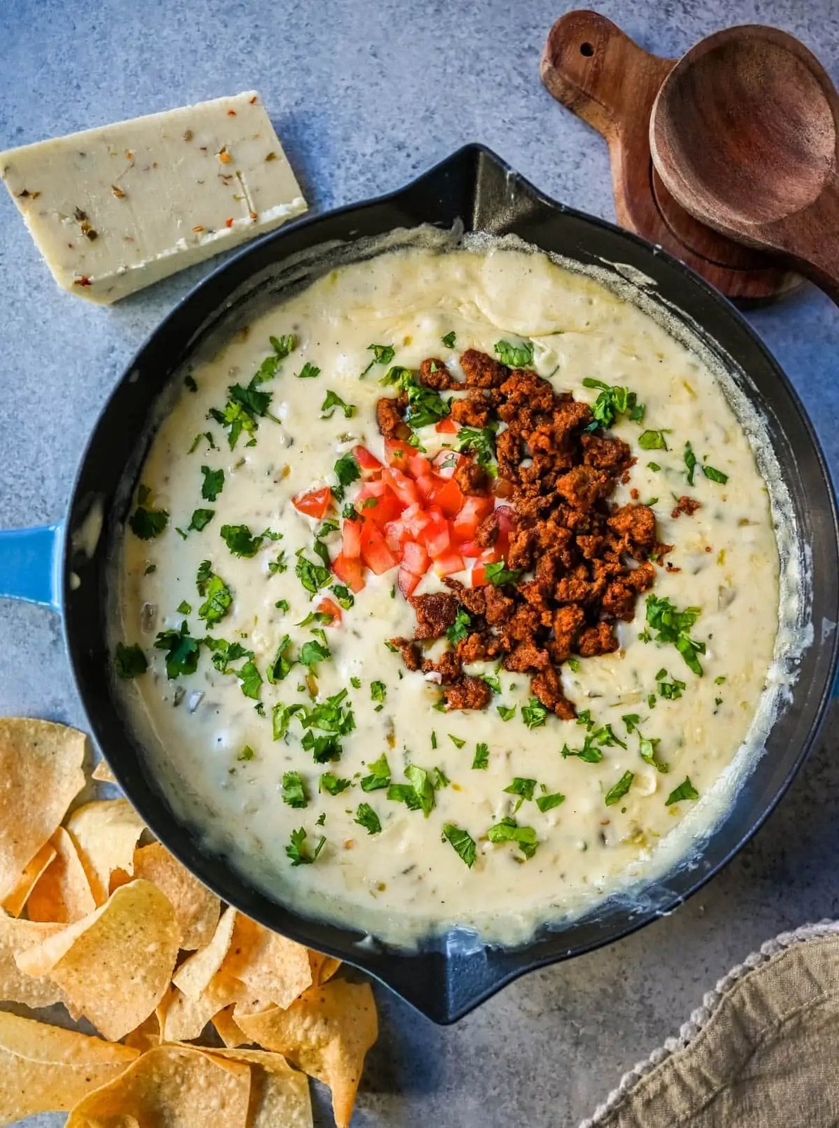 This creamy white queso dip is made with white American cheese, pepper jack, sautéed onion, garlic, and evaporated milk, it melts into the ultimate restaurant-style queso at home. The best rich easy queso recipe! I am sharing pro tips to keep it silky and never grainy.