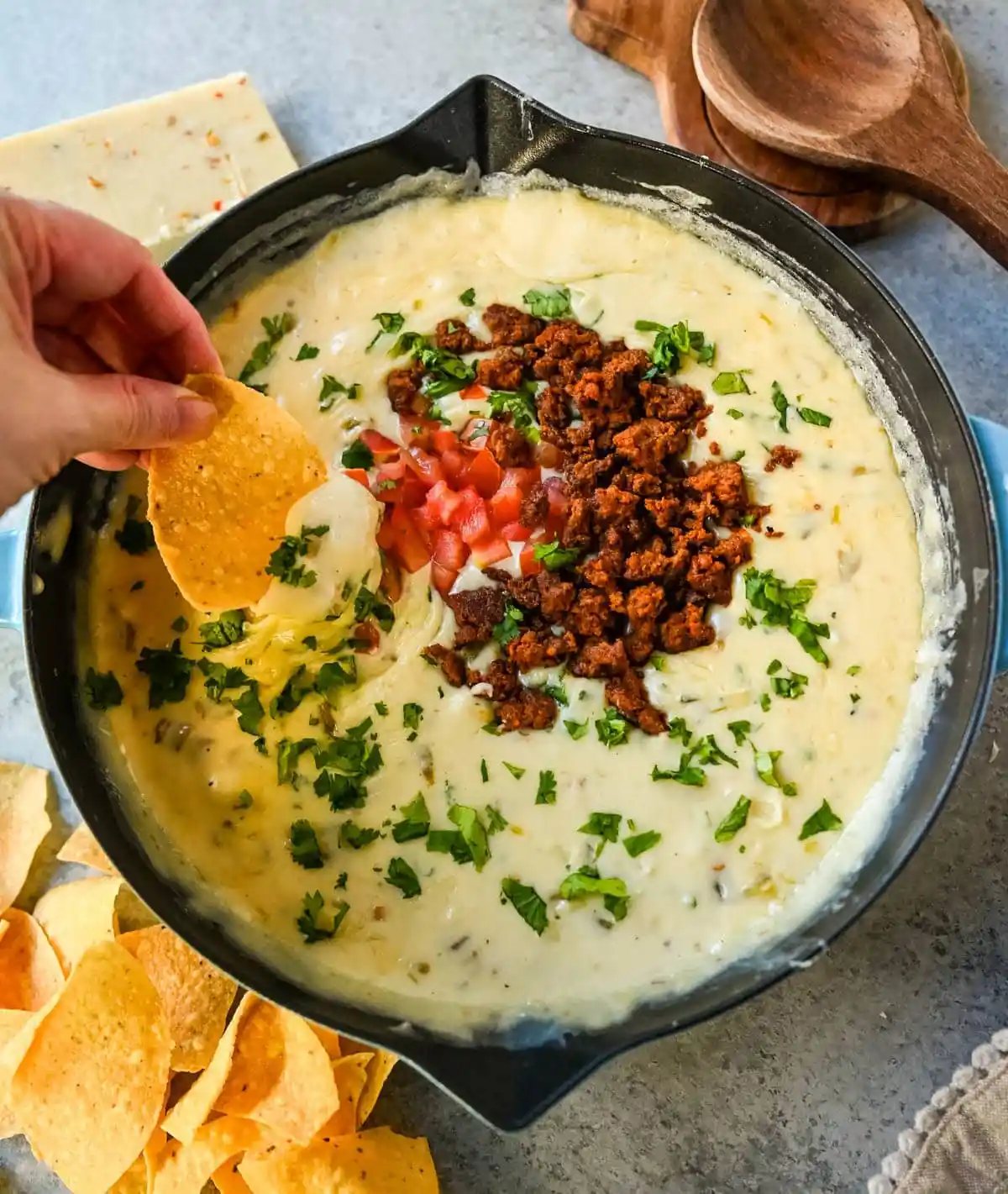 This creamy white queso dip is made with white American cheese, pepper jack, sautéed onion, garlic, and evaporated milk, it melts into the ultimate restaurant-style queso at home. The best rich easy queso recipe! I am sharing pro tips to keep it silky and never grainy.