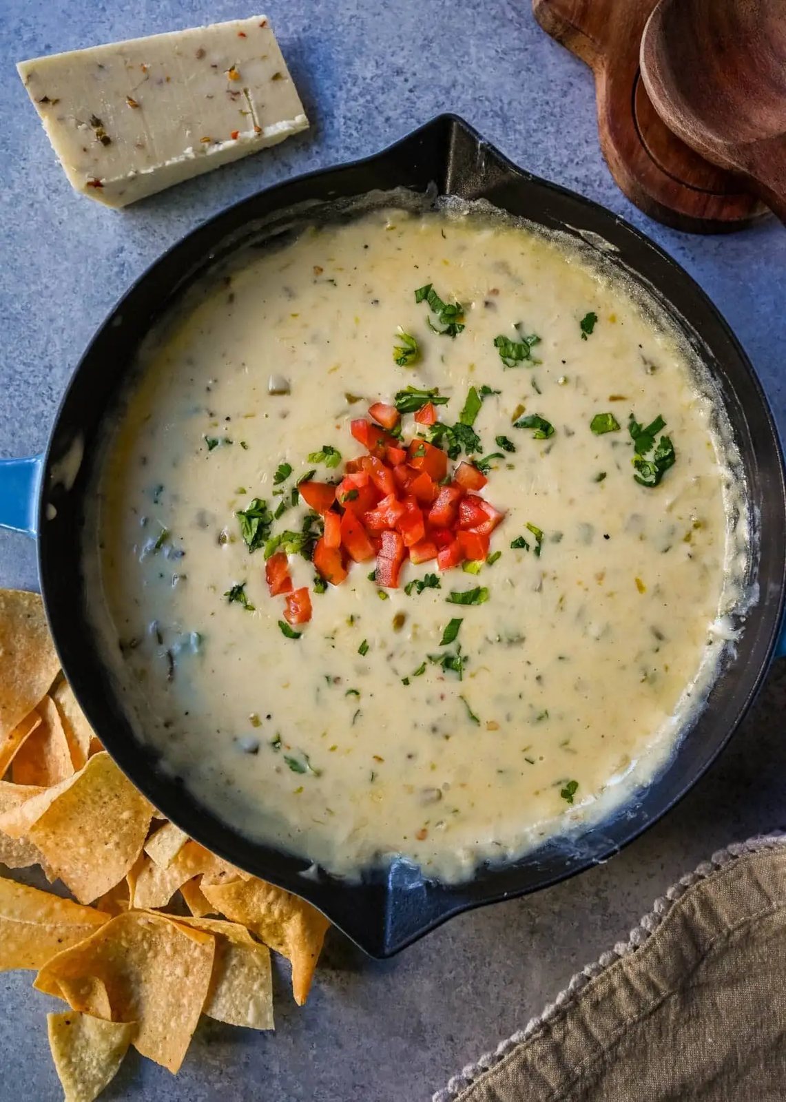 This creamy white queso dip is made with white American cheese, pepper jack, sautéed onion, garlic, and evaporated milk, it melts into the ultimate restaurant-style queso at home. The best rich easy queso recipe! I am sharing pro tips to keep it silky and never grainy.