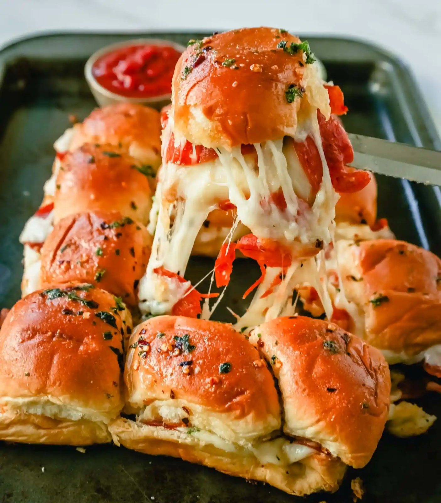 Pizza Sliders. Hawaiian Rolls Pizza Sliders made with Pepperoni, Mozzarella Cheese, and Provolone Cheese baked inside of soft, sweet rolls topped with warmed garlic butter and dipped in marinara sauce. The perfect party food!