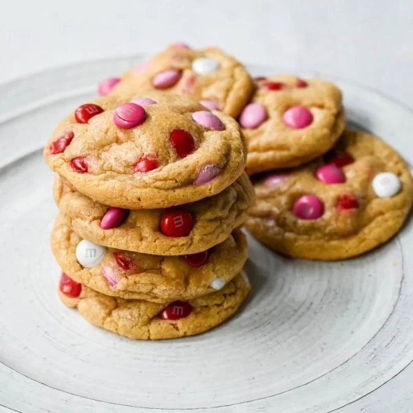 How to make the perfect Valentine's Day cookies. These soft and chewy Valentine's M&M Cookies have pops of pink, red, and white M&M's to make them not only delicious but festive and fun as well. You will love these Valentine's cookies!