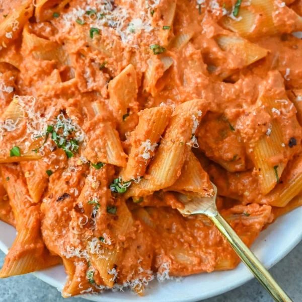 Penne alla Vodka is a classic Italian-American dish featuring a rich, creamy tomato sauce with a touch of vodka. While the alcohol cooks off, the vodka adds a subtle depth and brightness that sets this recipe apart from a standard marinara or tomato cream sauce. You will love this Love at First Bite Pasta!