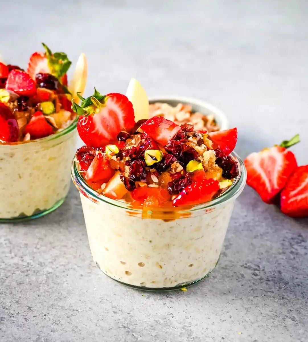 This overnight oats recipe also called Bircher Muesli is made by soaking oats overnight with juice, milk, honey, vanilla, and greek yogurt and then fold in vanilla whipped cream for extra creaminess and topped with fresh fruits, dried fruits, and nuts. It is the perfect and delicious easy, grab-and-go breakfast.