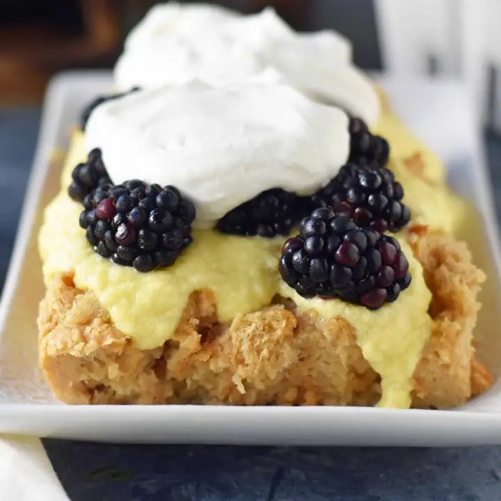 Blackberry Bread Pudding made with a warm brown sugar bread pudding topped with homemade creme anglaise sauce and fresh whipped cream. www.modernhoney.com