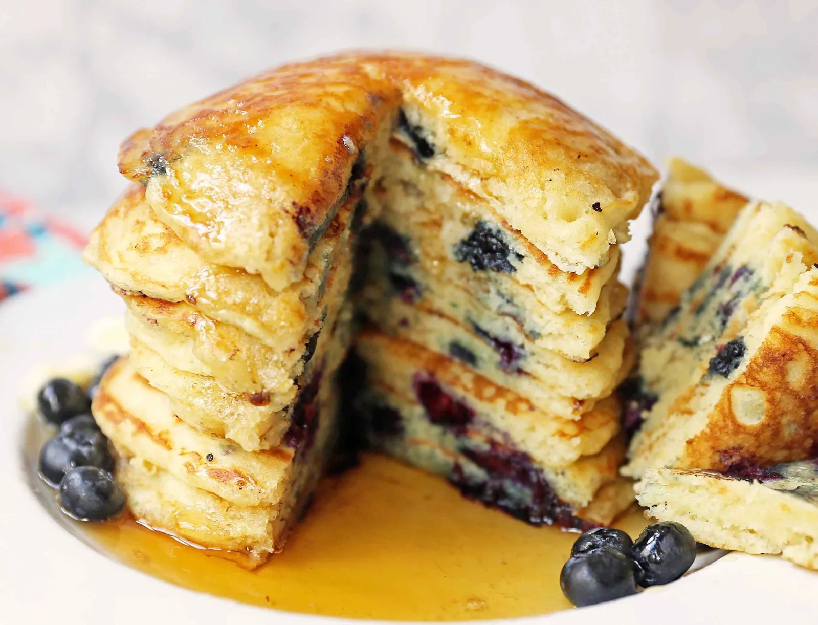 Homemade fluffy blueberry pancakes are made with fresh blueberries and are the best buttermilk blueberry pancakes ever! These are easy blueberry pancakes made from scratch.