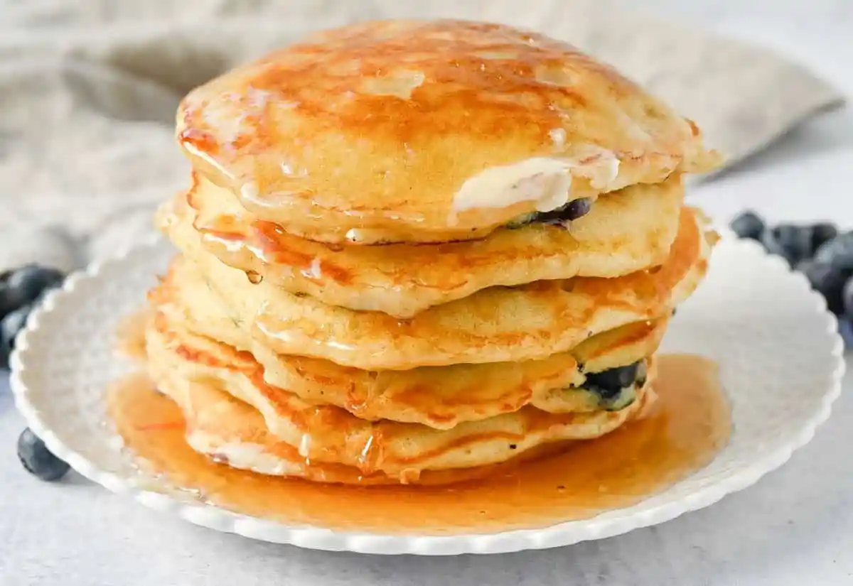 Homemade fluffy blueberry pancakes are made with fresh blueberries and are the best buttermilk blueberry pancakes ever! These are easy blueberry pancakes made from scratch.