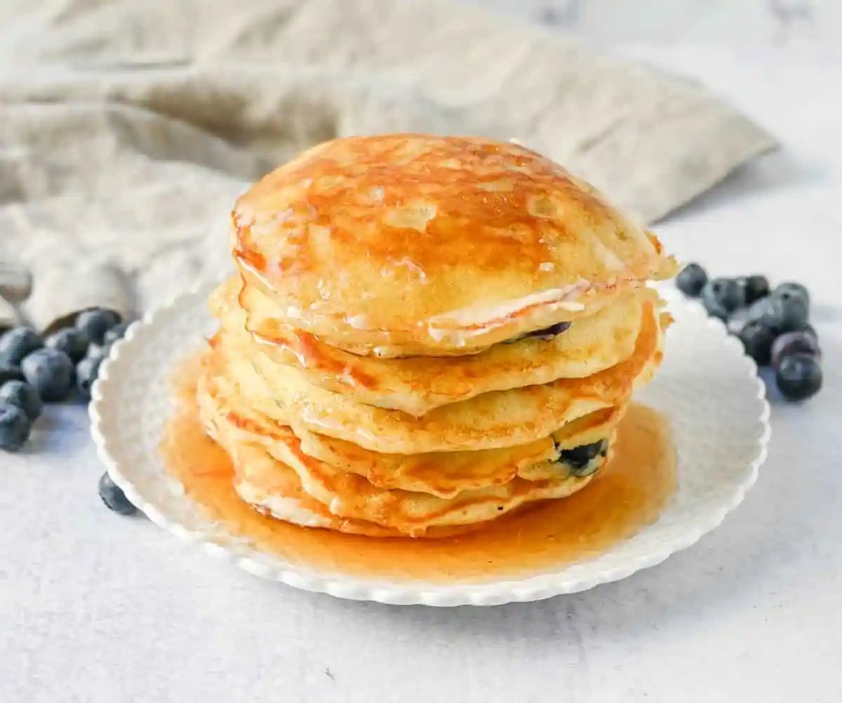 Homemade fluffy blueberry pancakes are made with fresh blueberries and are the best buttermilk blueberry pancakes ever! These are easy blueberry pancakes made from scratch.
