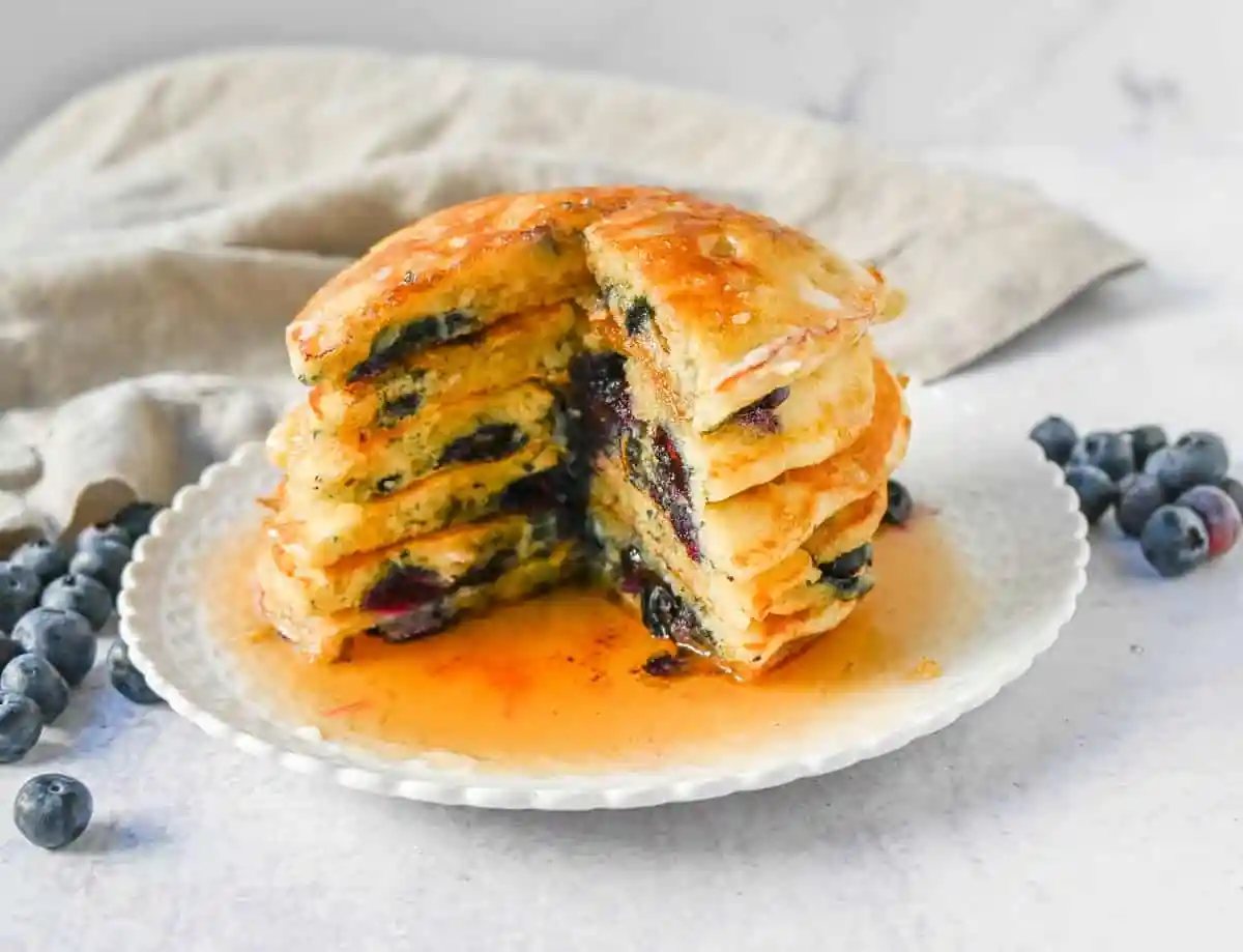Homemade fluffy blueberry pancakes are made with fresh blueberries and are the best buttermilk blueberry pancakes ever! These are easy blueberry pancakes made from scratch.