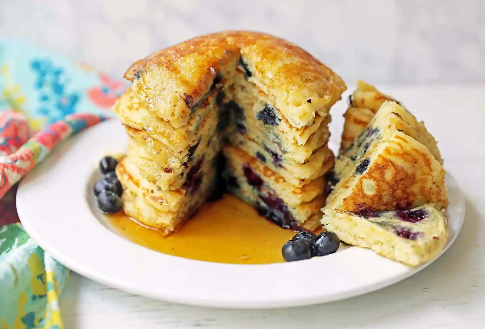 Homemade fluffy blueberry pancakes are made with fresh blueberries and are the best buttermilk blueberry pancakes ever! These are easy blueberry pancakes made from scratch.
