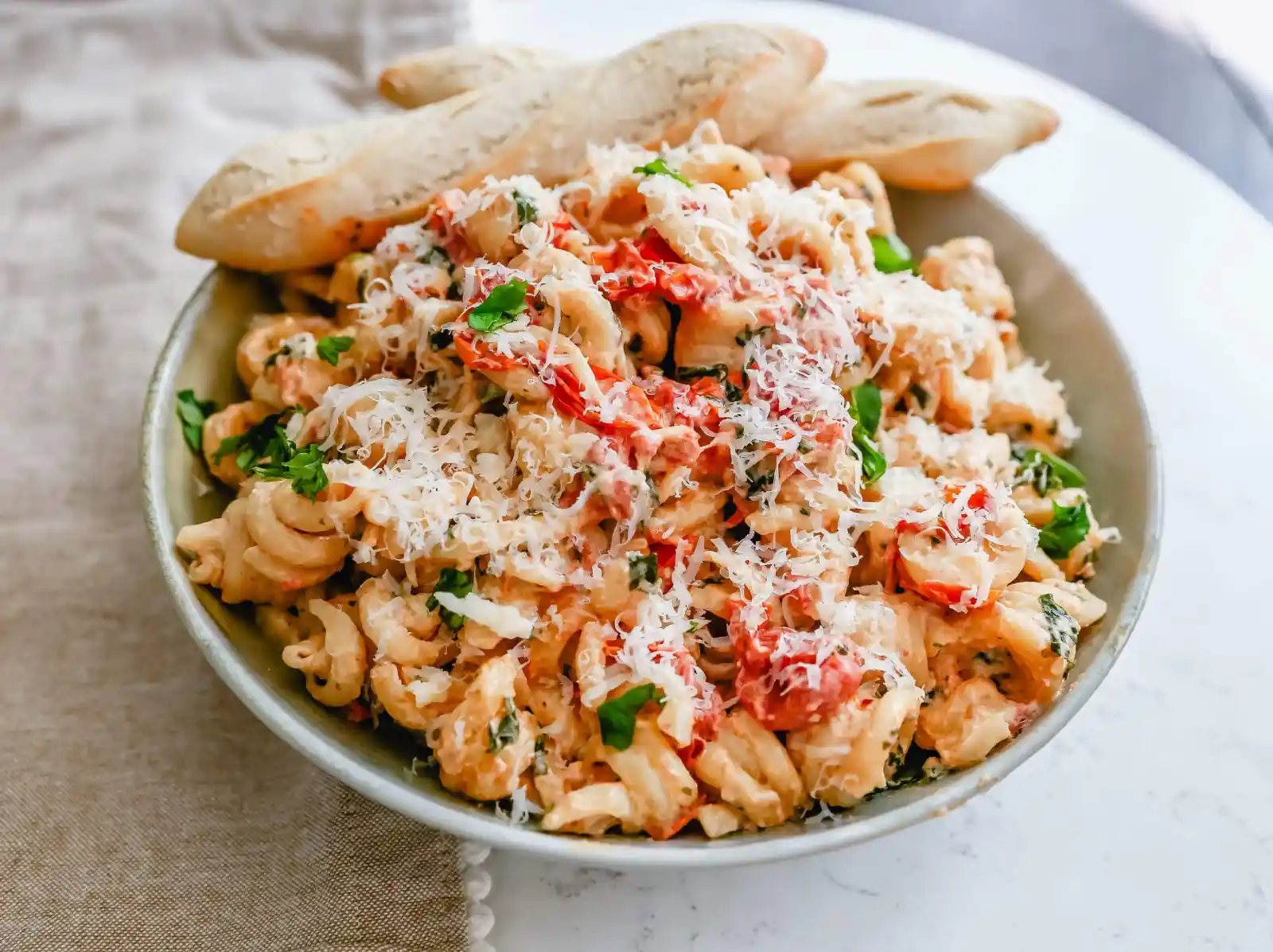 Boursin Cheese Baked TikTok Pasta Freshly cooked pasta tossed with baked Boursin cheese, tomatoes, garlic, spices, and parmesan cheese. This easy-baked pasta recipe will knock your socks off! #pasta #bakedpasta #tiktokpasta